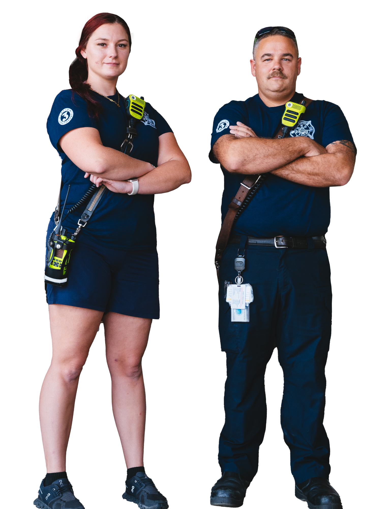 A woman and man firefighters standing next to each other with their arms crossed.